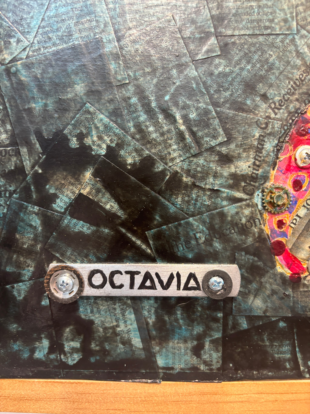 Octavia — close-up of orange tentacle with screws and magenta sucker detail by Rita Irvin