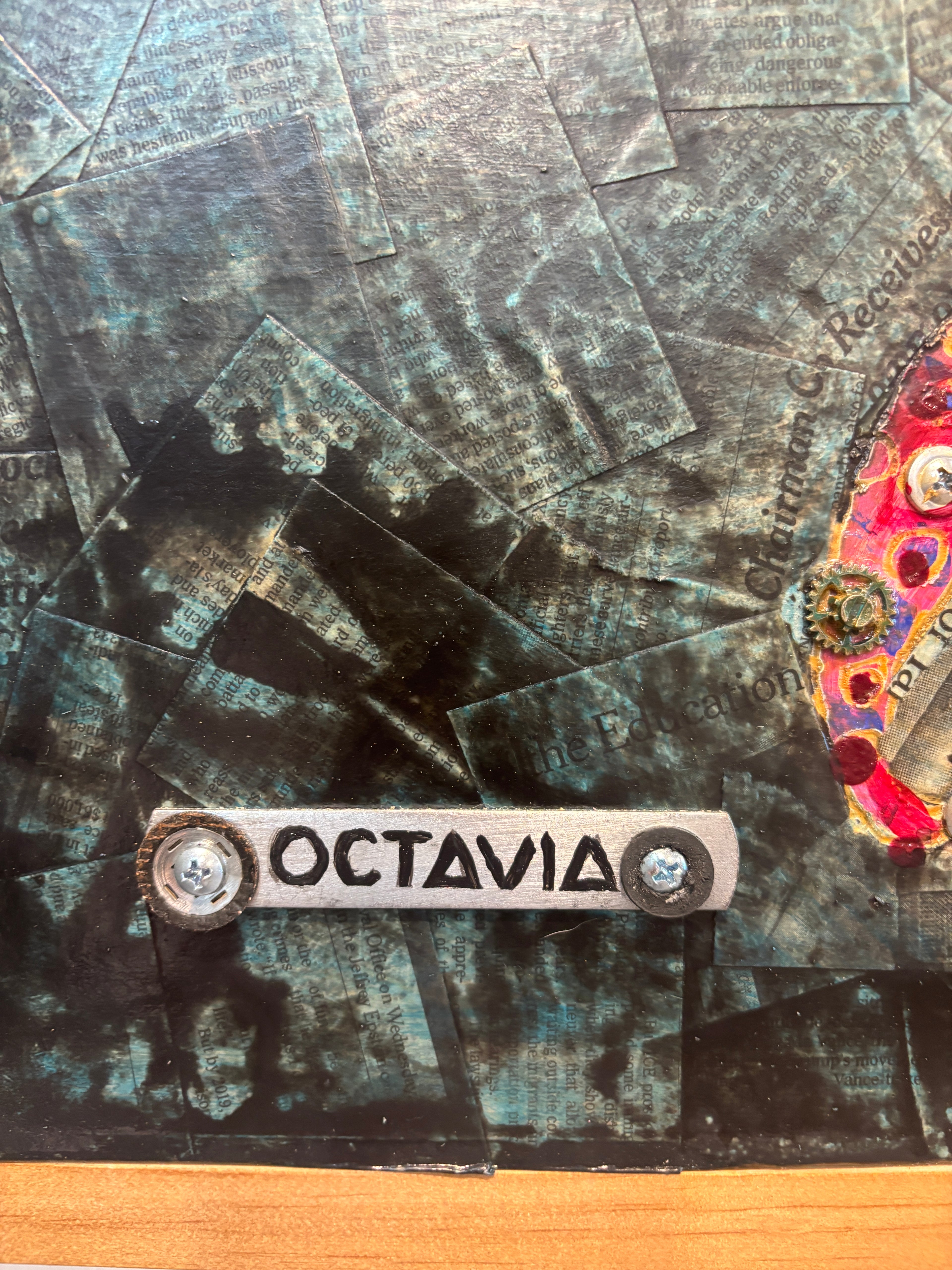 Octavia — close-up of orange tentacle with screws and magenta sucker detail by Rita Irvin